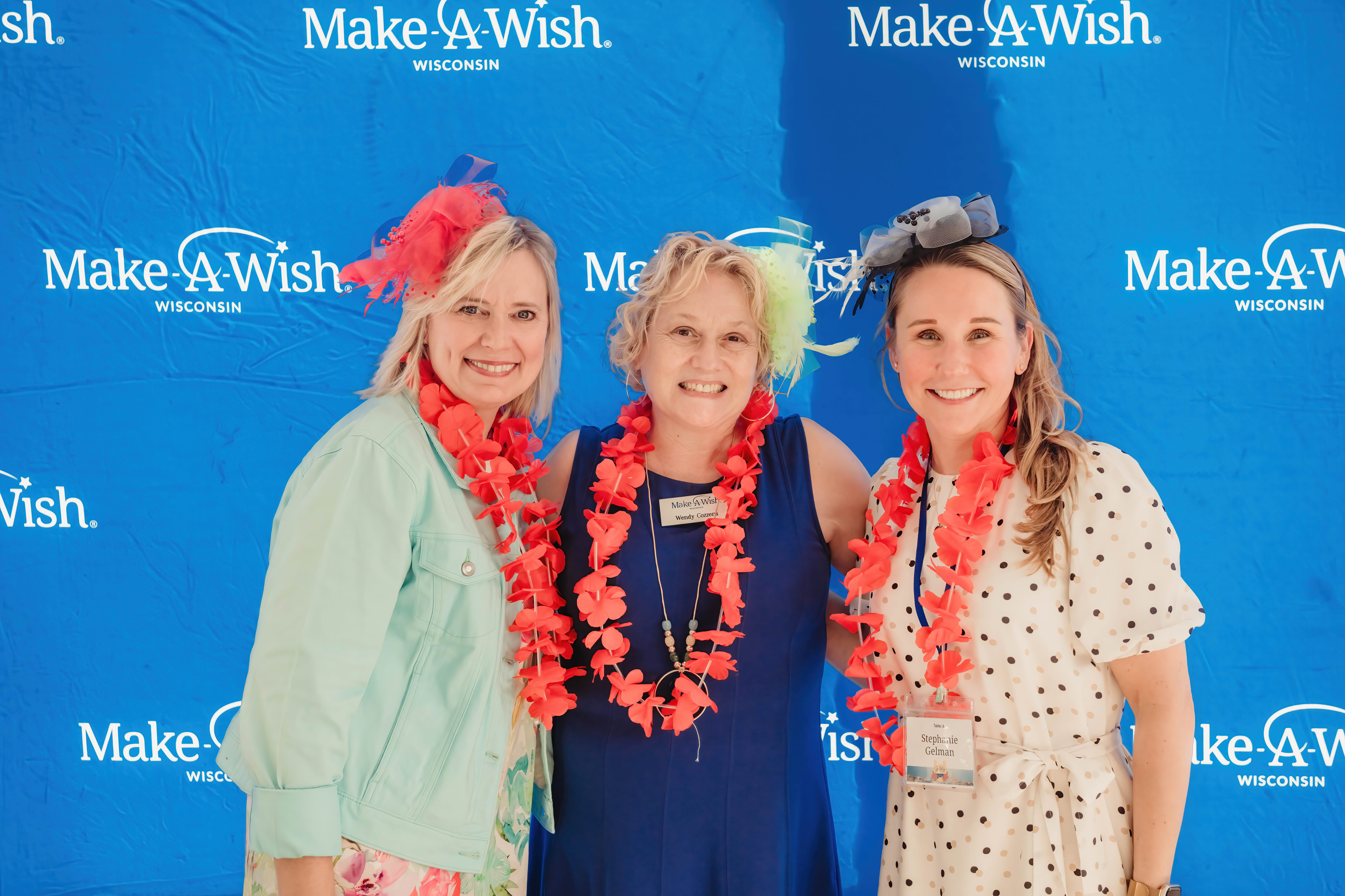 Two Exact Sciences team members pose with Make-A-Wish Wisconsin CEO Wendy Cozzens at Wishes By the Bay.